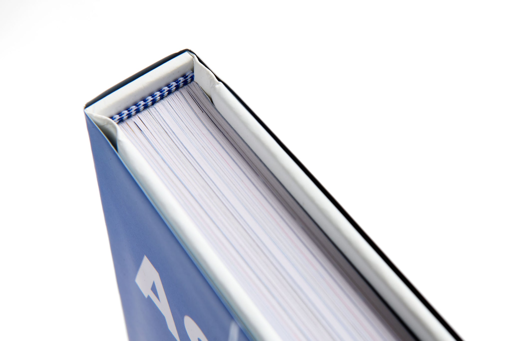 Close-up of a blue book with white pages on a white background